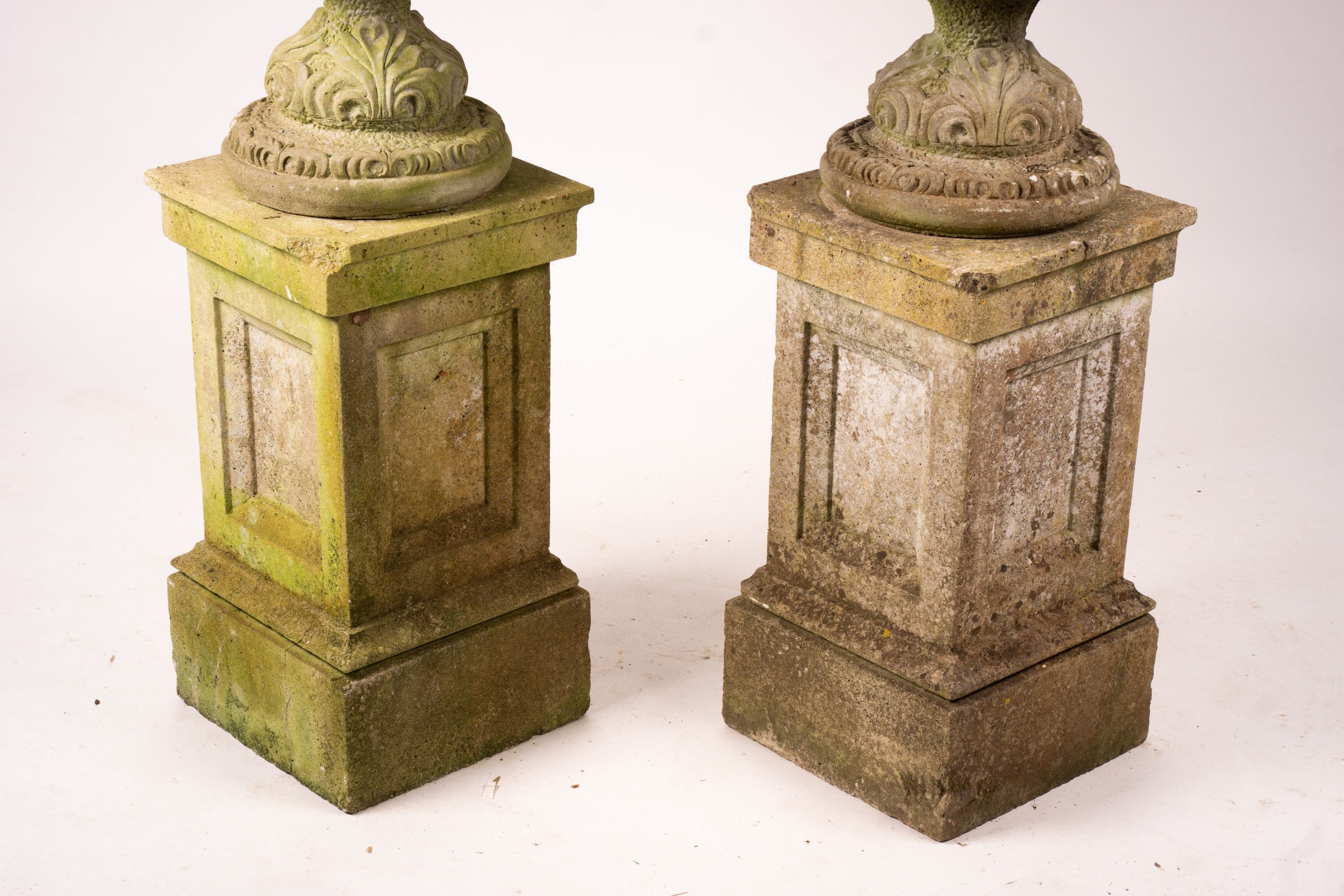 A pair of reconstituted stone circular garden planters on pedestal bases, diameter 45cm, height 110cm